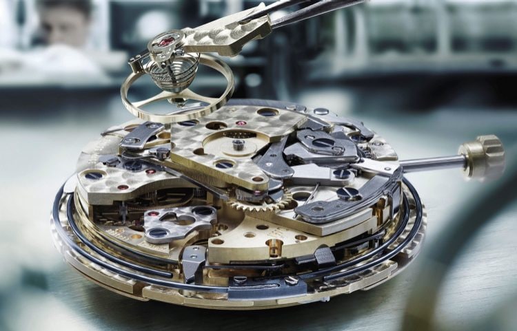 Close-up image of IWC watch mechanism and components inside watch dial