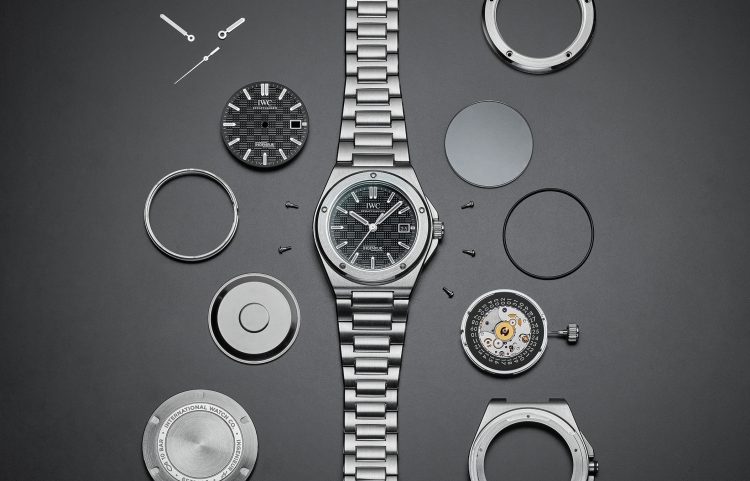 Ingenieur Automatic 40 with black dial and stainless steel bracelet, divided into its parts on grey background