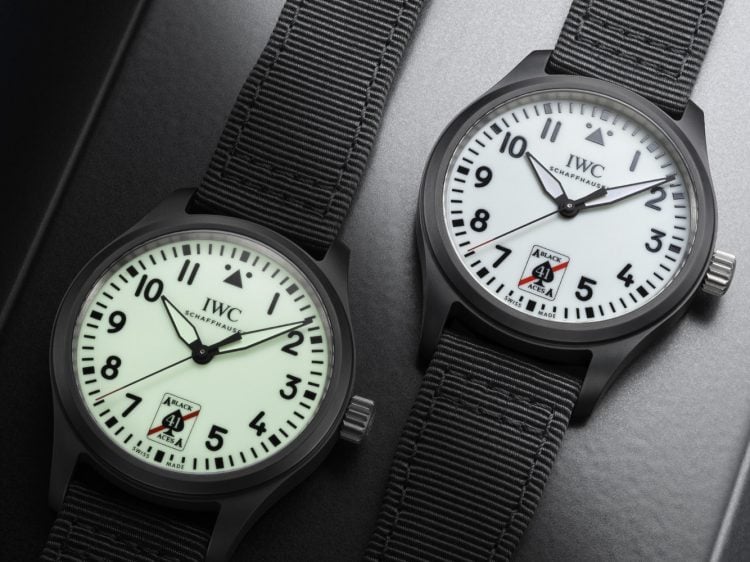 The Pilot’s Watch Automatic 41 Black Aces side by side, the left watch dial is displaying it's greenish glow in the dark functionality