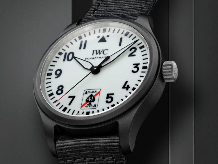 Close up of the Pilot’s Watch Automatic 41 Black Aces case. Black case and strap, white dial with black numbers and in place of 6 'o'clock, features a stylized Ace of Spades logo with red stripe and the number 41