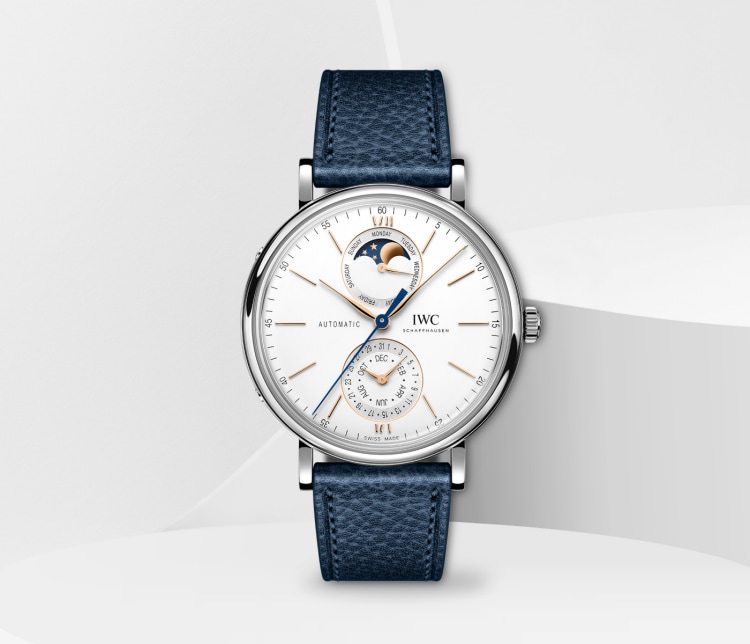 Image of IWC Portofino Complete Calendar IW359001 with white dial, silver case and blue calfskin strap placed on white surface in white background.