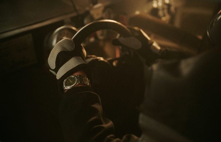 Closeup image of a man's wrist inside and aircraft, wearing the Ingenieur Automatic 40 green dial