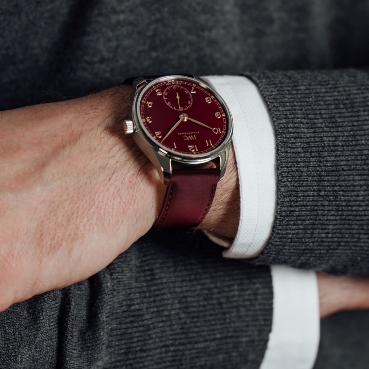 Close-up shot of a man wearing Portugieser Automatic 40 Edition "Chinese New Year" with burgundy dial and burgunday strap